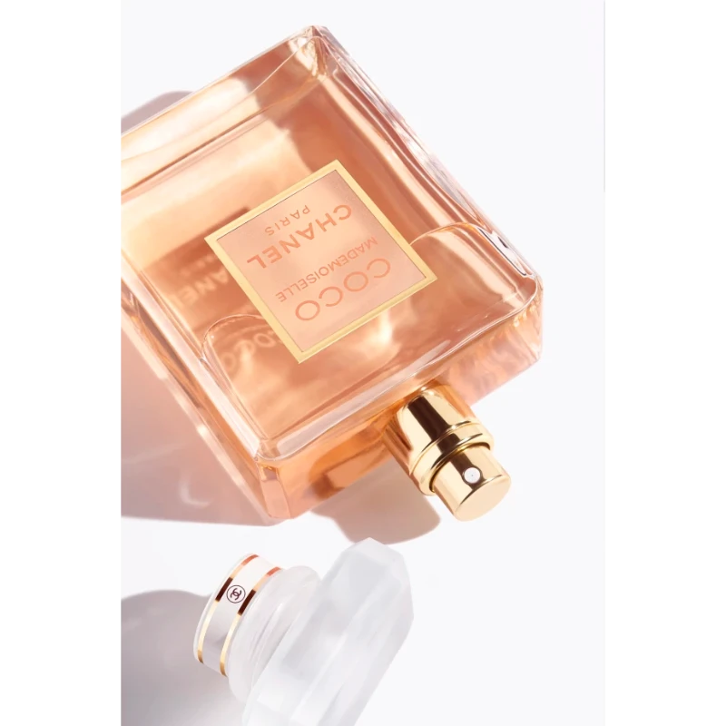 A transparent glass perfume bottle with a gold cap, featuring the Coco Mademoiselle logo. The bottle contains Coco Mademoiselle Eau de Parfum 100ML.