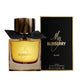 A sleek black glass perfume bottle with a gold cap, featuring the Burberry My Burberry Black logo. The bottle contains Burberry My Burberry Black For Women Eau De Parfum, with a volume of 90ml.