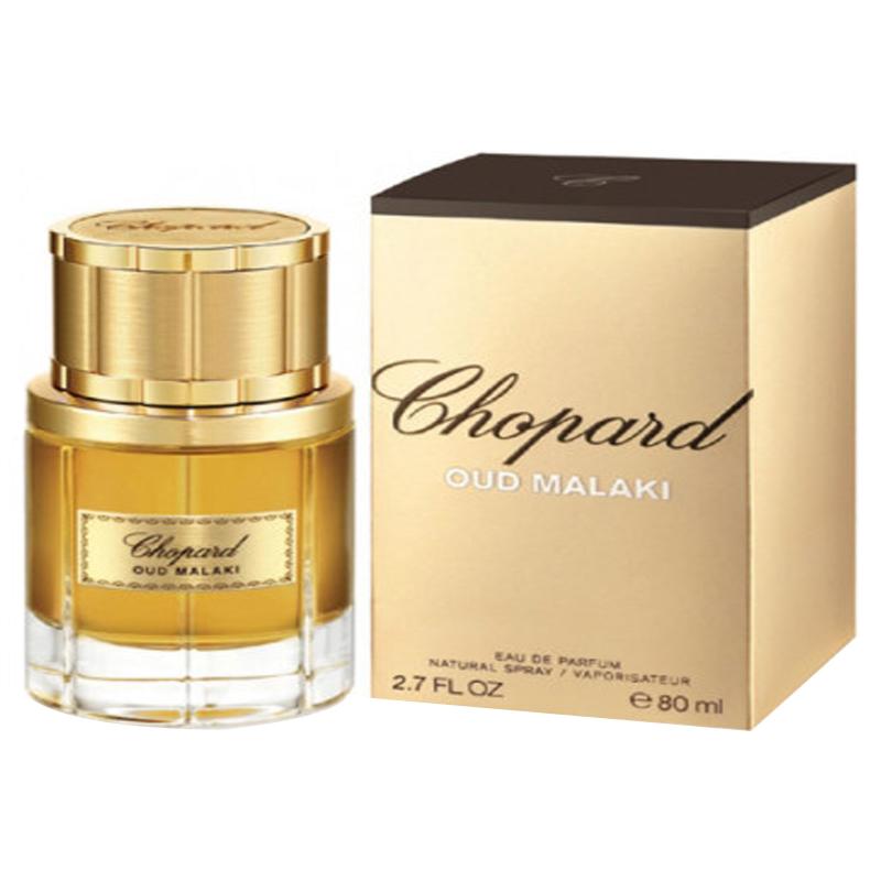 A glass perfume bottle containing Chopard Oud Malaki for Men. The bottle has a luxurious design, and the liquid inside is a deep amber color.