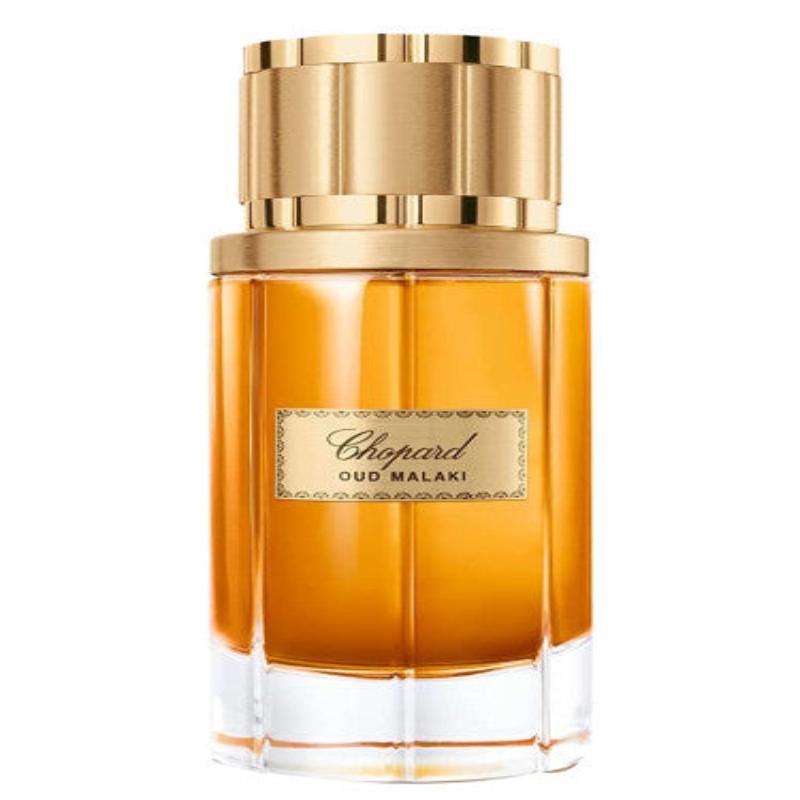 A glass perfume bottle containing Chopard Oud Malaki for Men. The bottle has a luxurious design, and the liquid inside is a deep amber color.