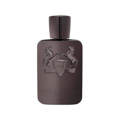 A luxurious, amber-colored perfume bottle with a simple, elegant design. The perfume is Parfums de Marly Herod, a complex and sophisticated fragrance for both men and women.