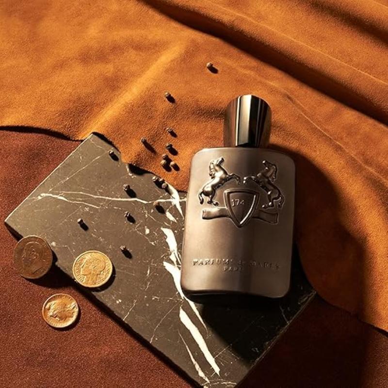 A luxurious, amber-colored perfume bottle with a simple, elegant design. The perfume is Parfums de Marly Herod, a complex and sophisticated fragrance for both men and women.