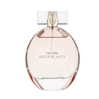 A translucent pink glass perfume bottle with a silver cap, featuring the Calvin Klein Sheer Beauty logo. The bottle contains CK Sheer Beauty Eau de Toilette, with a volume of 100ml.