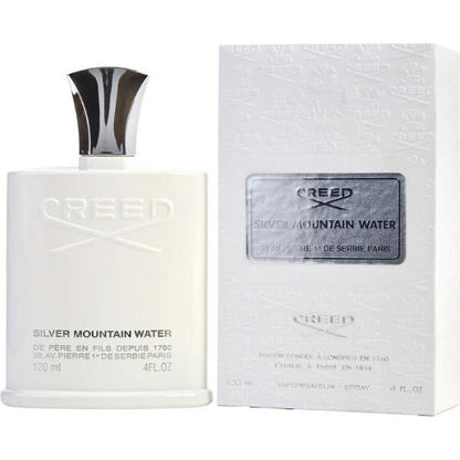 A clear glass perfume bottle containing Creed Silver Mountain Water Eau de Parfum. The bottle has a sleek, minimalist design with a silver cap. The liquid inside is a clear, refreshing color.