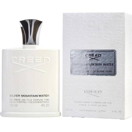 A clear glass perfume bottle containing Creed Silver Mountain Water Eau de Parfum. The bottle has a sleek, minimalist design with a silver cap. The liquid inside is a clear, refreshing color.