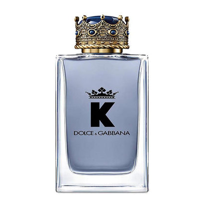 A sleek, masculine glass perfume bottle containing Dolce & Gabbana K Eau de Toilette. The bottle features a bold, modern design with a dark blue hue, suggesting a sophisticated and masculine fragrance